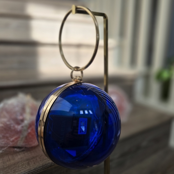 Cobalt blue wristlet round ball, gold trim and gold crossbody chain. - Picture 2 of 9